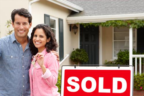 couple outside sold home