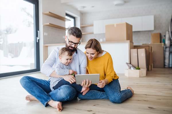Young Family Moving In a New Home