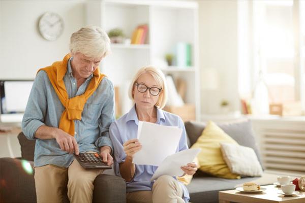 Senior Couple Calculating  Taxes / Debt